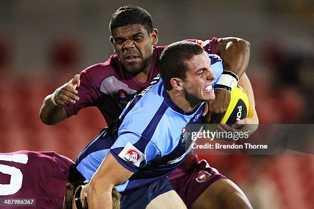 Adam Elliott of the NSW is tackled by Kierran Moseley of QLD during the U20's State of Origin match between the New South Wales Blues and the...