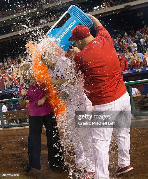 Cameron Rupp and Ken Giles of the Philadelphia Phillies dump Powerade on Cody Asche after Asche hit a walk-off two-run home run in the bottom of the...