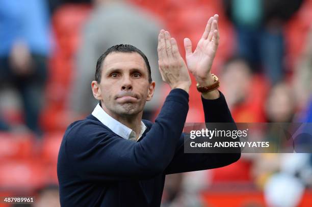 Sunderland's Uruguayan manager Gus Poyet applauds after Sunderland won the English Premier League football match between Manchester United and...