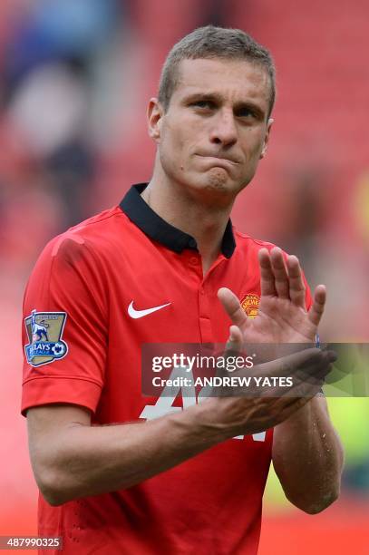 Manchester United's Serbian defender Nemanja Vidic reacts as he leaves the field at the end of the English Premier League football match between...