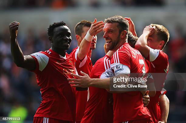 Rickie Lambert of Southampton celebrates with team mates as he scores their first goal during the Barclays Premier League match between Swansea City...