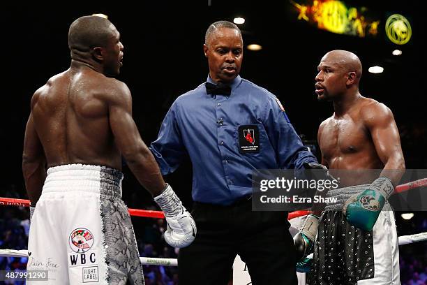 Floyd Mayweather Jr. And Andre Berto stare each other down at the end of the round during their WBC/WBA welterweight title fight at MGM Grand Garden...