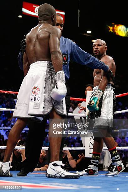 Floyd Mayweather Jr. And Andre Berto stare each other down at the end of the round during their WBC/WBA welterweight title fight at MGM Grand Garden...
