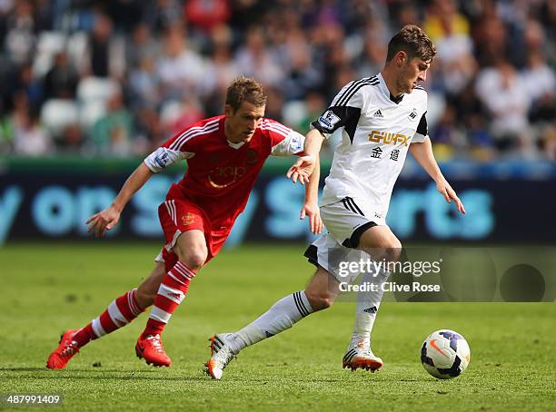 Ben Davies of Swansea City evades Steven Davis of Southampton during the Barclays Premier League match between Swansea City and Southampton at...