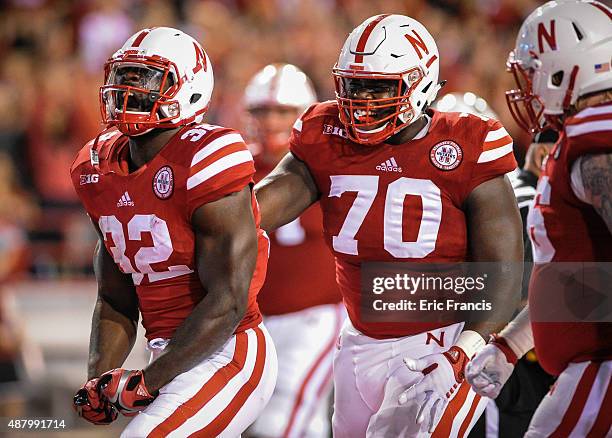 Running back Imani Cross and offensive lineman Chongo Kondolo of the Nebraska Cornhuskers celebrate a score during a game at Memorial Stadium on...