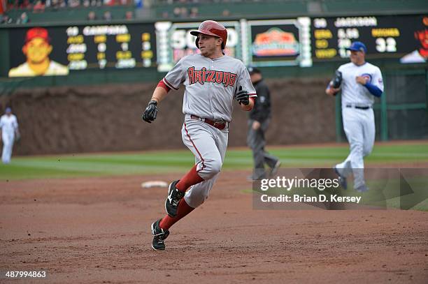 Tony Campana of the Arizona Diamondbacks arrives at third base after hitting an RBI triple scoring Cliff Pennington during the second inning against...