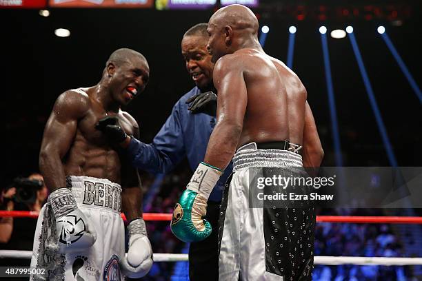 Referee Kenny Bayless stops the fight to admonish Floyd Mayweather Jr. And Andre Berto for verbal exchanges during their WBC/WBA welterweight title...