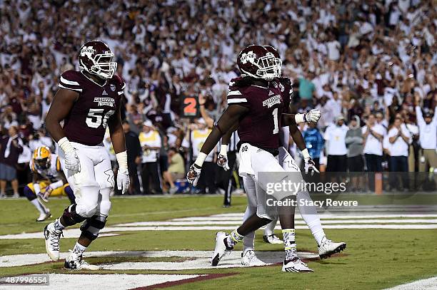 De'Runnya Wilson of the Mississippi State Bulldogs celebrates a touchdown against the LSU Tigers during the fourth quarter of a game at Davis Wade...