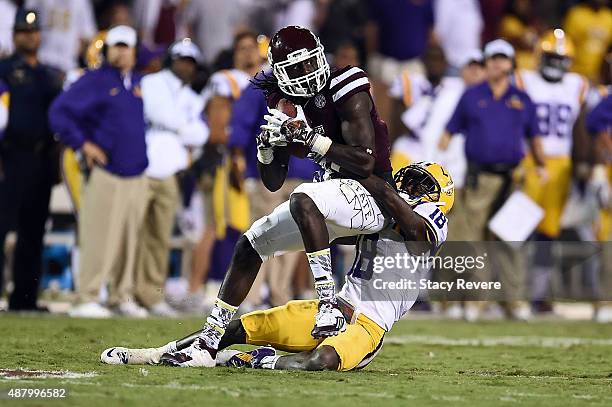 De'Runnya Wilson of the Mississippi State Bulldogs is brought down by Tre'Davious White of the LSU Tigers during the fourth quarter of a game at...