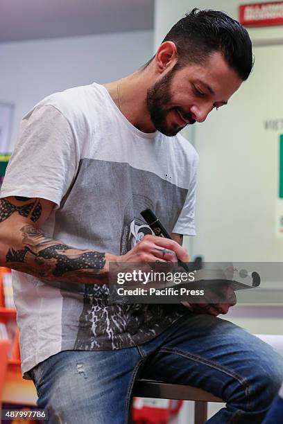 The Italian rapper and songwriter Francesco Tarducci, also known as "Nesli", signs autograph of his first novel titled "Andrà tutto bene". At...