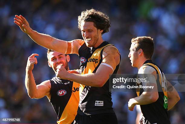 Tyrone Vickery of the Tigers is congratulated by Chris Newman and Kane Lambert after kicking a goal during the First AFL Elimination Final match...