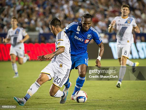 Didier Drogba of Montreal Impact battles A.J. DeLaGarza of Los Angeles Galaxy during Los Angeles Galaxy's MLS match against Montreal Impact at the...