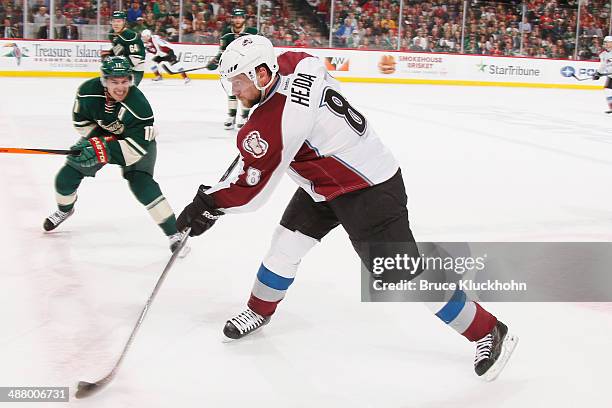 Jan Hejda of the Colorado Avalanche dumps the puck against the Minnesota Wild during Game Six of the First Round of the 2014 Stanley Cup Playoffs on...