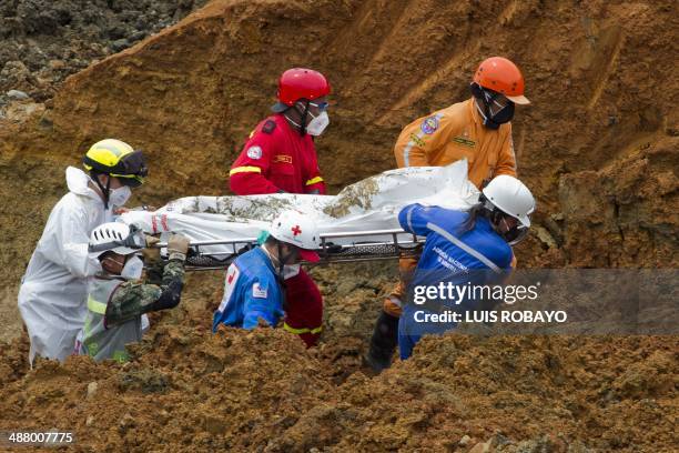 Colombian rescuers carry the corpse of one of the victims of a gold mine that collapsed --on May 1st-- while independent mine workers were excavating...