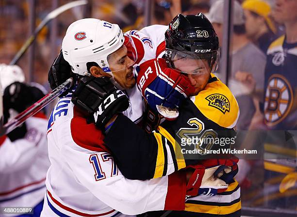 Daniel Paille of the Boston Bruins and Rene Bourque of the Montreal Canadiens get into a scuffle in the second period in Game Two of the Second Round...