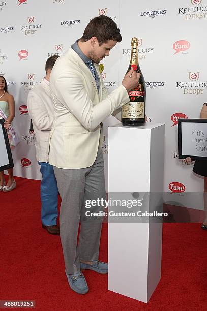 Kris Humphries toasts with Moet & Chandon at the 140th Kentucky Derby at Churchill Downs on May 3, 2014 in Louisville, Kentucky.