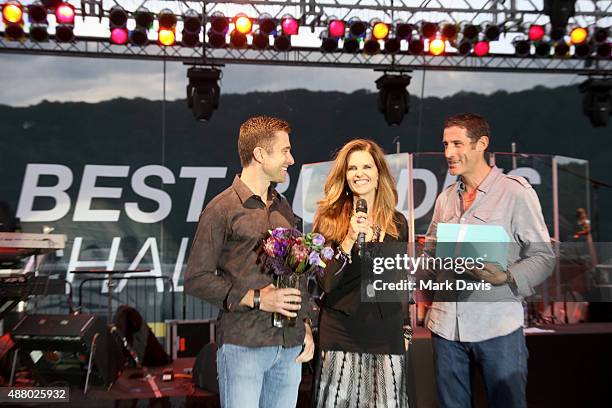 Professional cyclist Christian Vande Velde, Honorary Co-Chair Maria Shriver and professional cyclist George Hincapie speak onstage at the Hearst...