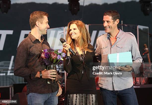 Professional cyclist Christian Vande Velde, Honorary Co-Chair Maria Shriver and professional cyclist George Hincapie speak onstage at the Hearst...