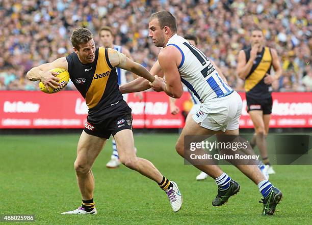 Kane Lambert of the Tigers is tackled by Ben Cunnington of the Kangaroos during the First AFL Elimination Final match between the Richmond Tigers and...