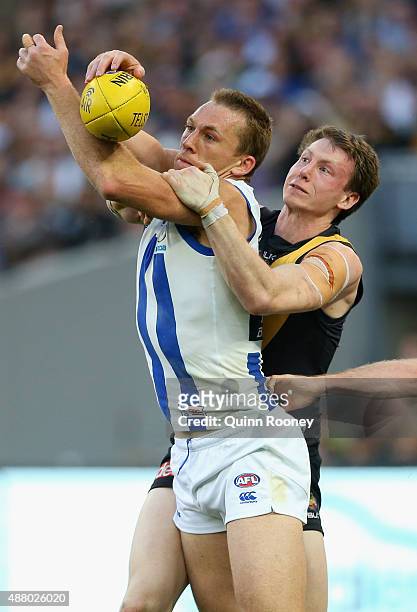 Drew Petrie of the Kangaroos marks infront of Dylan Grimes of the Tigers during the First AFL Elimination Final match between the Richmond Tigers and...