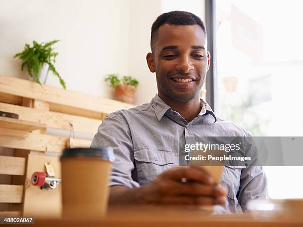 coffee and wireless freedom - african american restaurant texting stockfoto's en -beelden