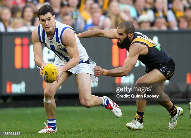 Scott Thompson of the Kangaroos is tackled by Bachar Houli of the Tigers during the First AFL Elimination Final match between the Richmond Tigers and...