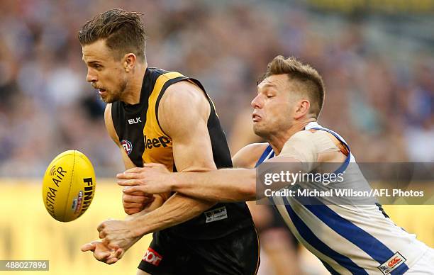 Brett Deledio of the Tigers is tackled by Shaun Higgins of the Kangaroos during the 2015 AFL First Elimination Final match between the Richmond...