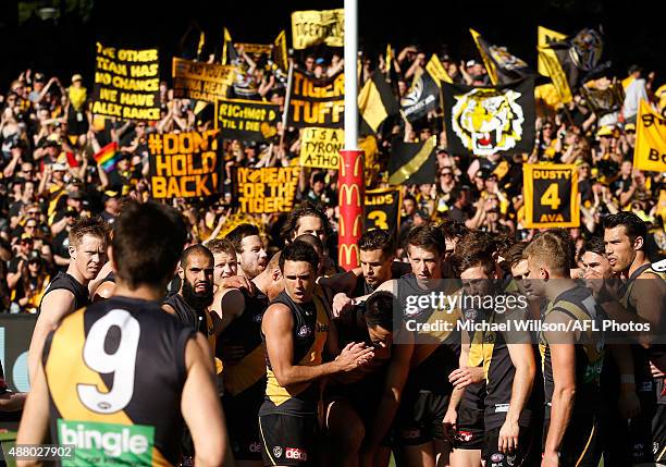 Trent Cotchin of the Tigers walks to address his players after the coin toss during the 2015 AFL First Elimination Final match between the Richmond...