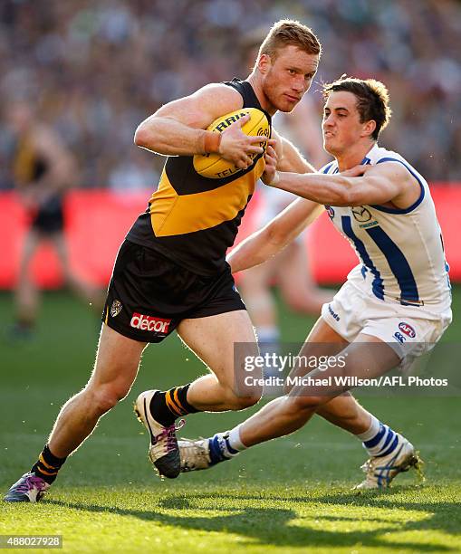 Nick Vlastuin of the Tigers is tackled by Taylor Garner of the Kangaroos during the 2015 AFL First Elimination Final match between the Richmond...