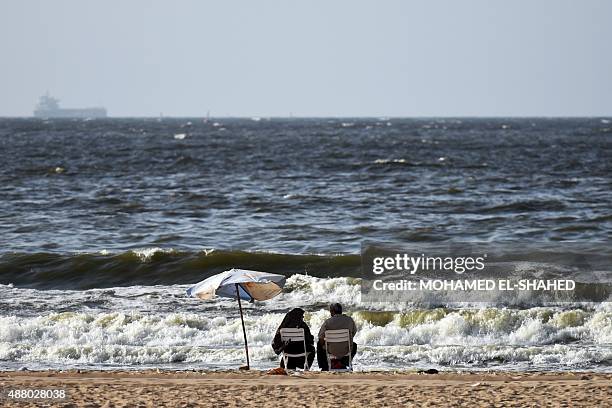 Egyptians sit on a beach on September 12, 2015 in the Egyptian port city of Alexandria. AFP PHOTO / MOHAMED EL-SHAHED