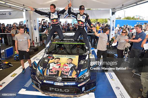 Sebastien Ogier of France and Julien Ingrassia of France celebrate their victory in the rally and their third World Rally Championship Title during...