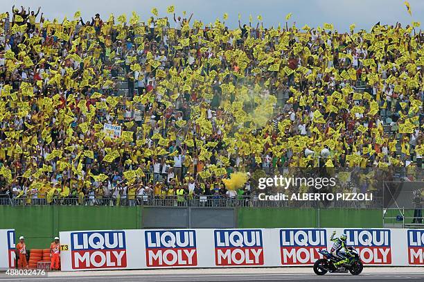 Movistar Yamaha MotoGP's Italian rider Valentino Rossi waves to his supporters before the Moto GP race of the San Marino MotoGP, in Misano Adriatico...