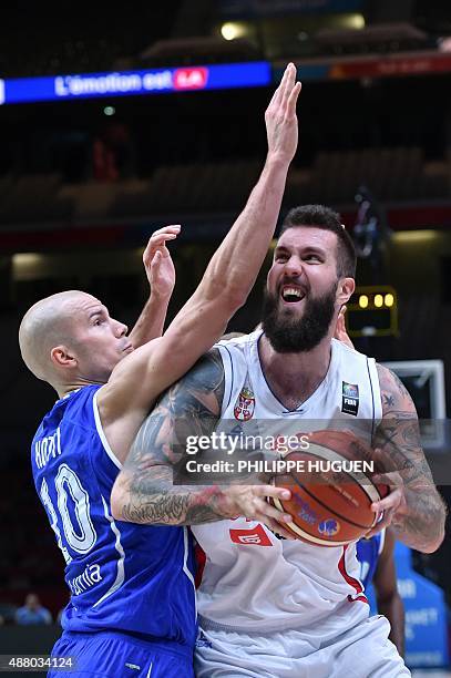 Finland's power forward Tuukka Kotti defends against Serbia's center Miroslav Raduljica during the round of 16 basketball match between Serbia and...