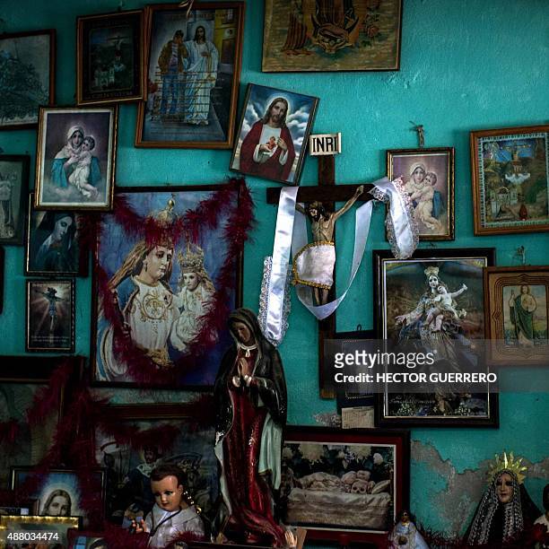 Altar with religious images that relatives and neighbors have placed in the home of the family of Julio Cesar Lopez Patolzin, one of the 43 missing...