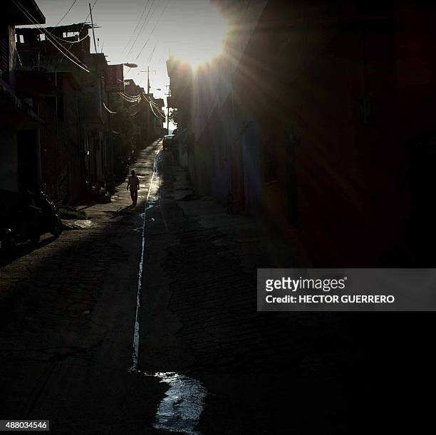 Man walks along a streer in Tixtla, Guerrero State, Mexico on August 14, 2015. Next September 26 will mark the first anniversary of the disappearance...