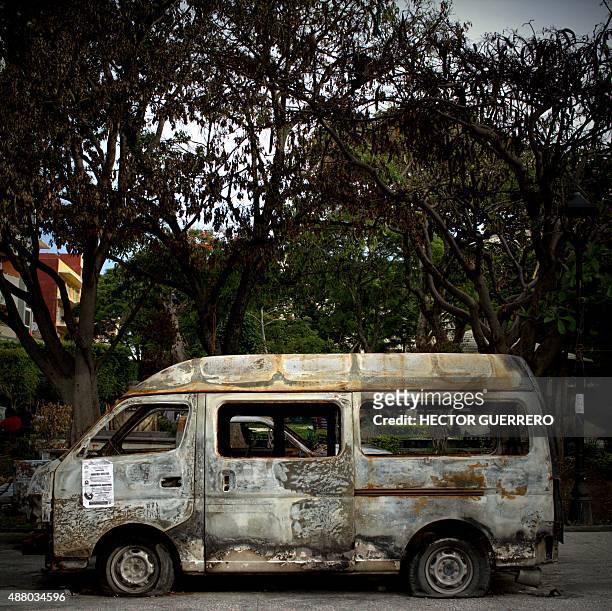 Burnt down microbus inside inside the camp mounted by the missing teachers and students at the main square of Chilpancingo, Guerrero State, Mexico on...