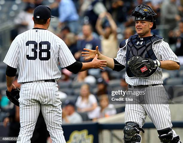 Preston Claiborne and Brian McCann of the New York Yankees celebrate the win over the Tampa Bay Rays on May 3, 2014 at Yankee Stadium in the Bronx...