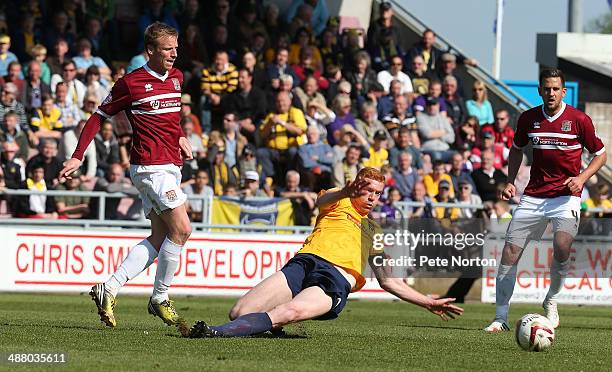 Ricky Ravenhill of Northampton Town plays the ball past the challenge of David Kitson of Oxford United during the Sky Bet League Two match between...