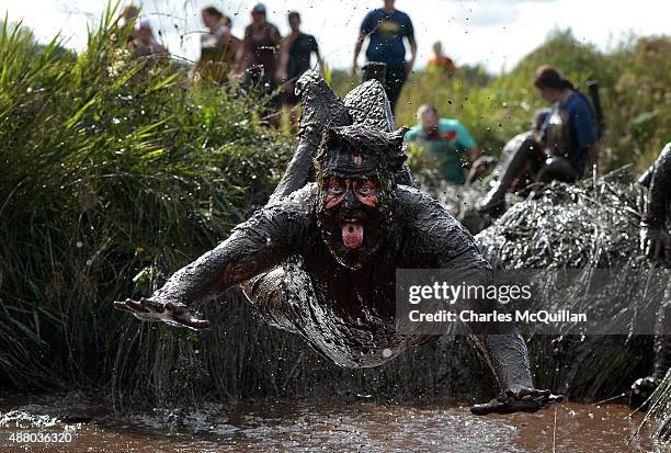 Competitor jumps head first into a mud pool as he takes part in the Mud Madness race at Foymore Lodge on September 13, 2015 in Portadown, Northern...