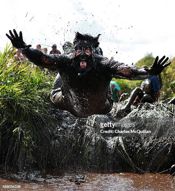 Competitor jumps head first into a mud pool as he takes part in the Mud Madness race at Foymore Lodge on September 13, 2015 in Portadown, Northern...