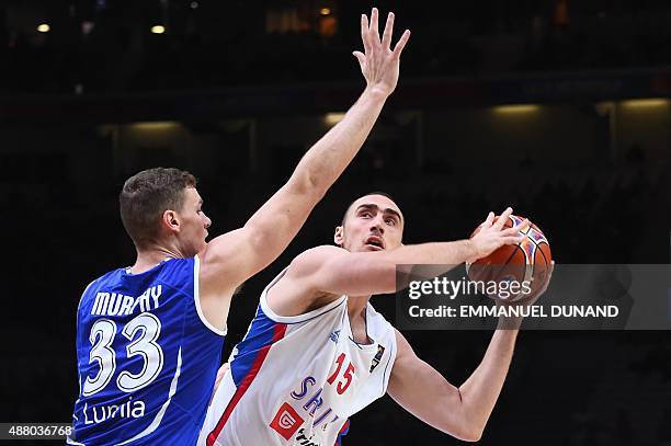 Finland's power forward Erik Murphy defends against Serbia's center Nikola Milutinov during the round of 16 basketball match between Serbia and...