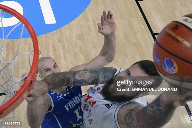 Serbia's center Miroslav Raduljica goes to the basket despite Finland's power forward Tuukka Kotti during the round of 16 basketball match between...