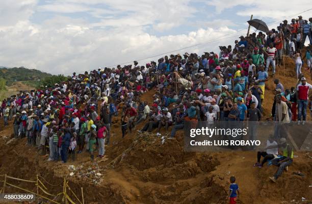 People look at rescue operations after an illegal gold mine collapsed past Thursday, in San Antonio, rural area of Santander de Quilichao, department...