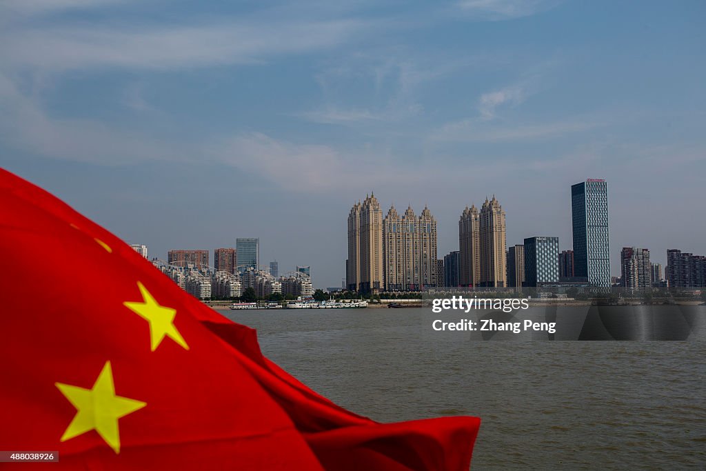 Chinese national flag is flying on the Yangtze river flowing...