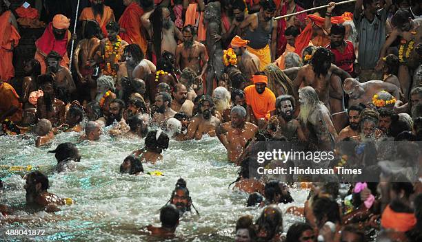 Sadhus of 10 akharas take bath on the auspicious day of Mauni Amavasya during the Maha Kumbh Mela at Trimbakeshwar, on September 13, 2015 in Nashik,...