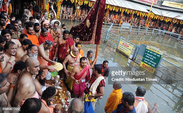 Sadhus of 10 akharas take bath on the auspicious day of Mauni Amavasya during the Maha Kumbh Mela at Trimbakeshwar, on September 13, 2015 in Nashik,...