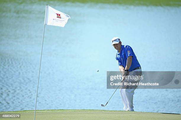 Holmes chips onto the 14th green during the third round of the Wells Fargo Championship at the Quail Hollow Club on May 3, 2014 in Charlotte, North...