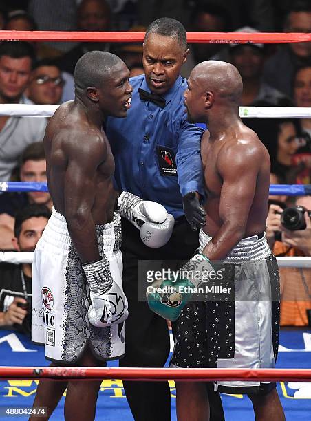 Referee Kenny Bayless separates Andre Berto and Floyd Mayweather Jr. During the seventh round of their WBC/WBA welterweight title fight at MGM Grand...
