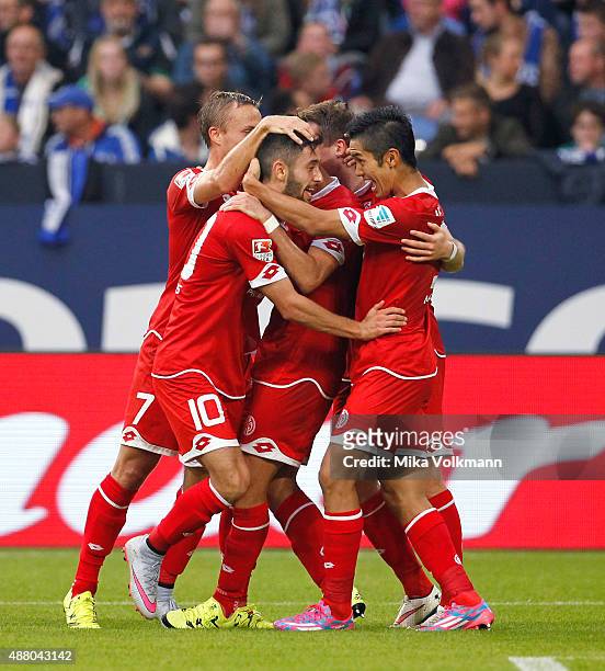Yunus Malli of Mainz celebrates scoring the 1:1 with Yoshinori Muto of Mainz and teammates during the Bundesliga match between FC Schalke 04 and 1....