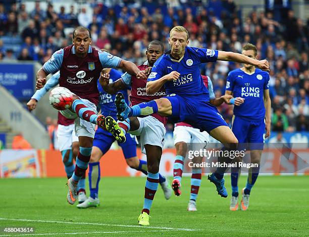 Ritchie De Laet of Leicester City beats Gabriel Agbonlahor and Leandro Bacuna of Aston Villa to score their first goal during the Barclays Premier...